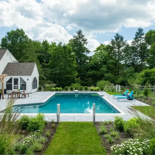 pool landscaping in massachusetts surrounded by trees and green grass
